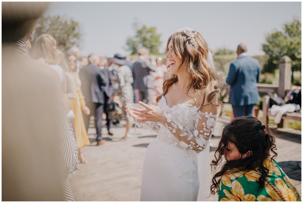 bride laughing outside holding a margarita at Cripps Barn Wedding