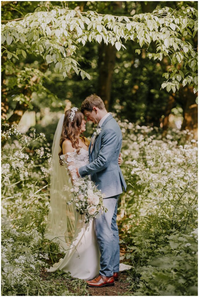 Bride and groom photos in the woodland at Cripps Barn wedding. Cripps Barn