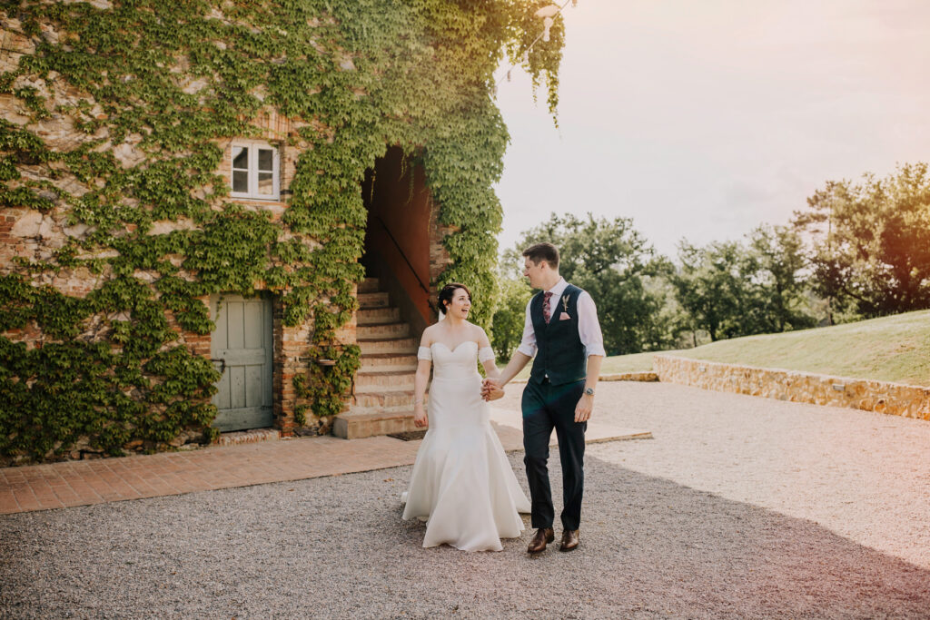 bride and groom walking and looking at each other at a villa podernovo wedding outside the front house