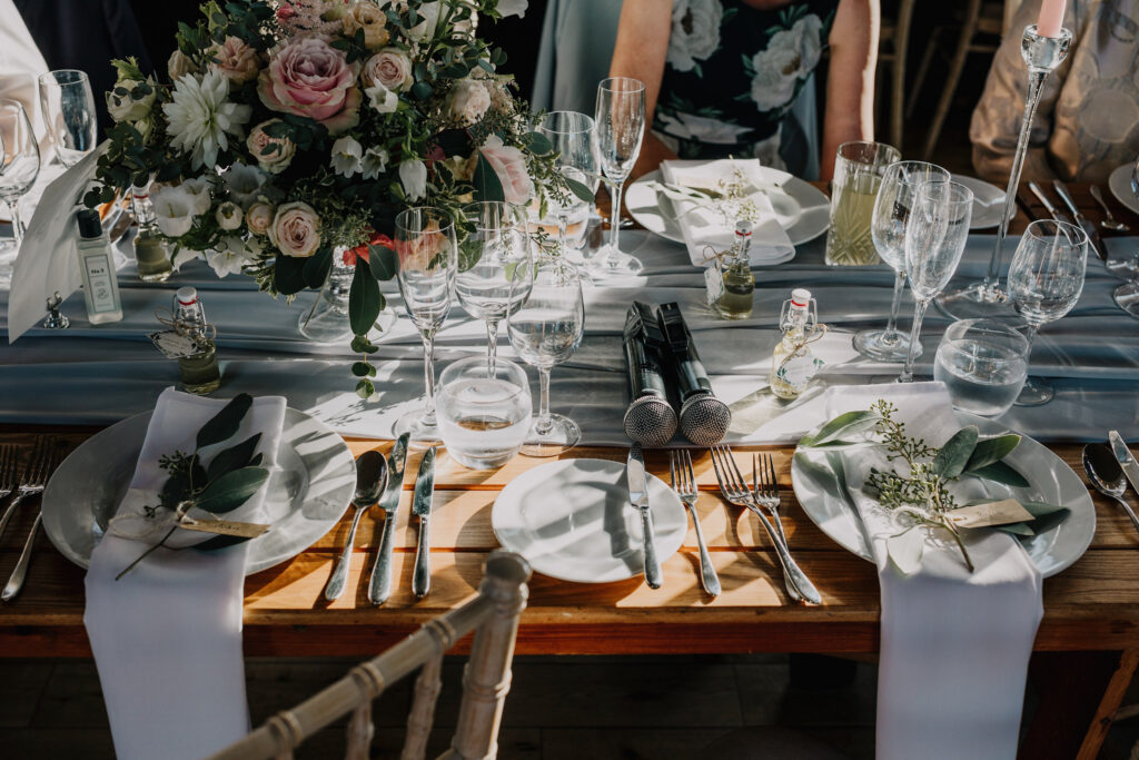 Wedding speeches taking place inside the Gillyflower at Elmore Court, with guests seated at long wooden tables.