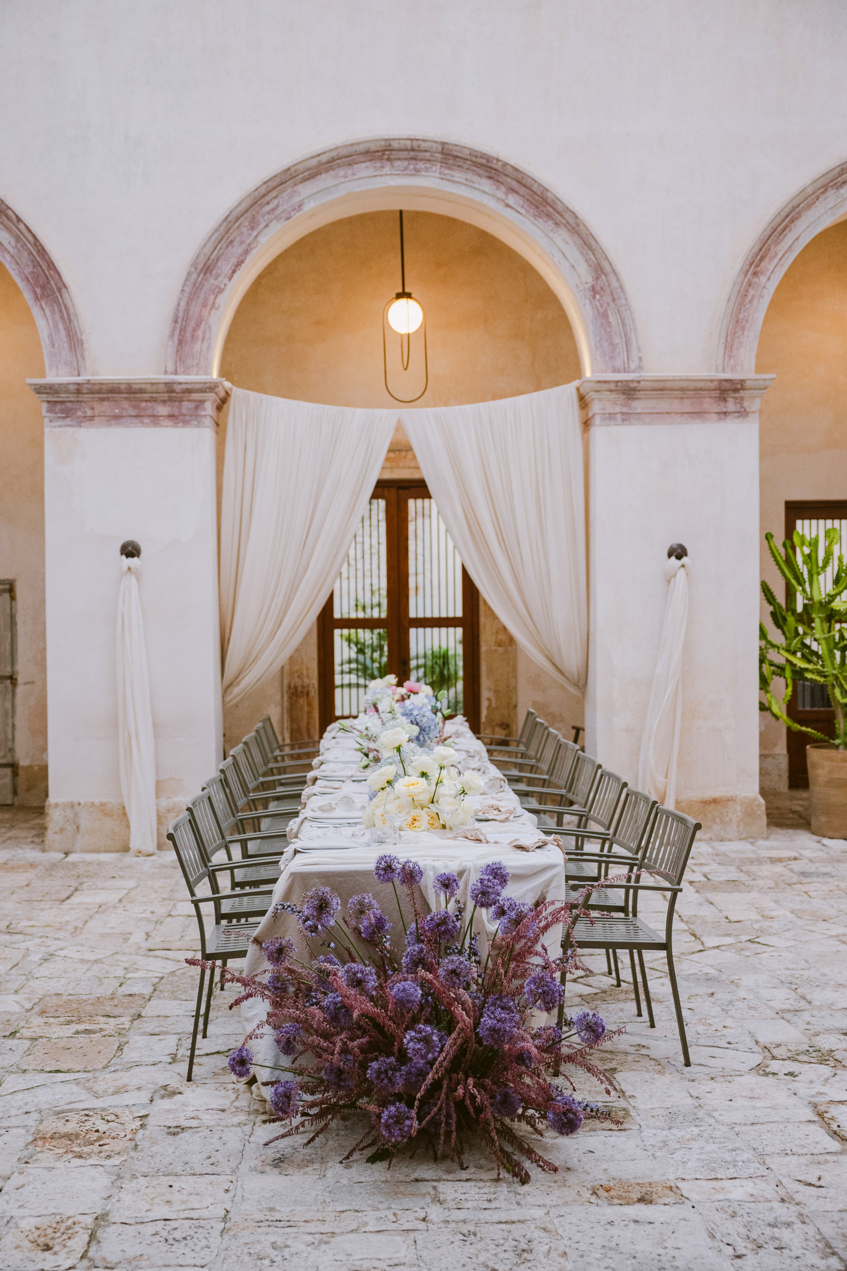 wedding breakfast set up with flowers and drapes at palazzo tafurri for a puglian wedding