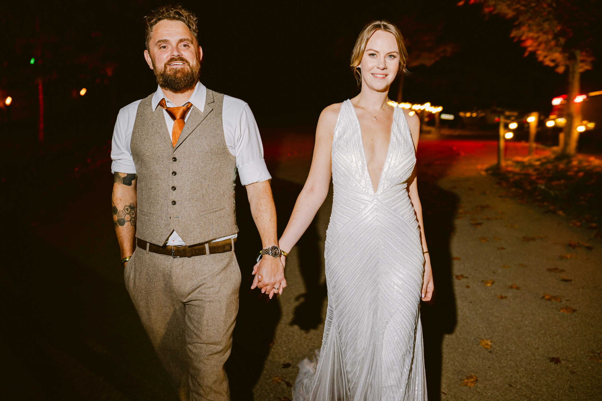 editorial style relaxed photo of wedding couple outside at Stone Barn. Bride wearing low cut wedding dress