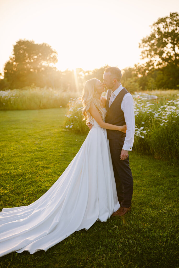 golden hour with a bride and groom in the meadow outside the Gillyflower at an Elmore Court wedding